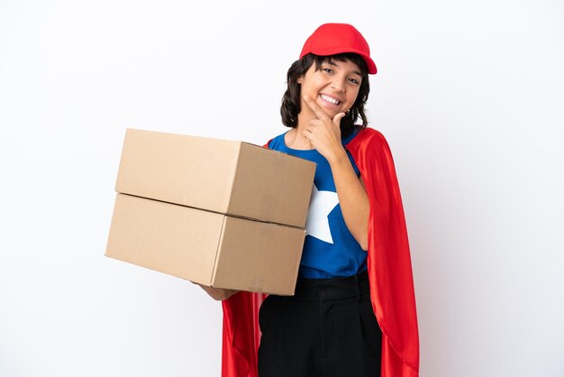 Young superhero delivery girl isolated on pink background happy and smiling