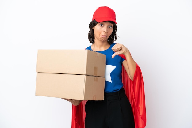 Young superhero delivery girl isolated on pink background showing thumb down with negative expression