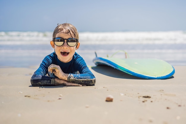 Young surfer happy young boy at the beach with surfboard