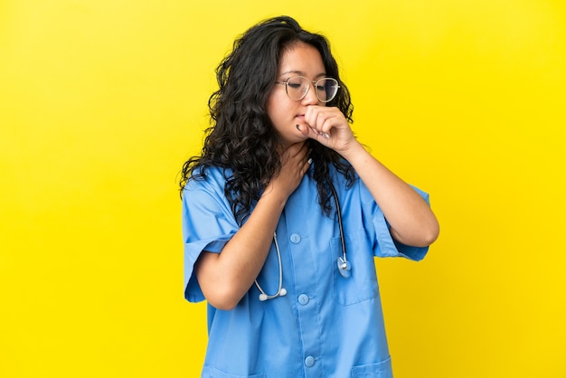 Young surgeon doctor asian woman isolated on yellow background is suffering with cough and feeling bad