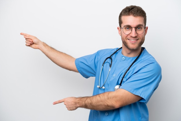 Young surgeon doctor caucasian man isolated on white background pointing finger to the side and presenting a product