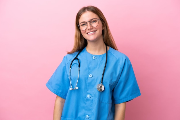Young surgeon doctor woman isolated on pink background with glasses and happy