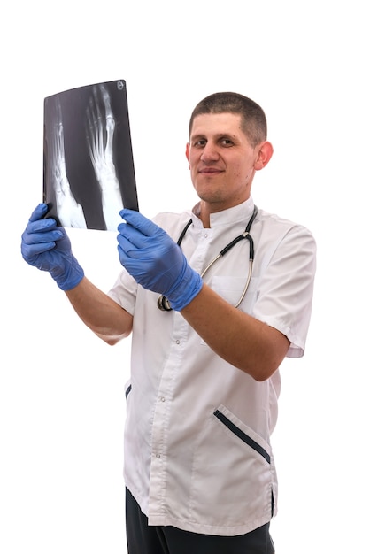 Young surgeon examining an x-ray image foot of the patient  isolated on white background.