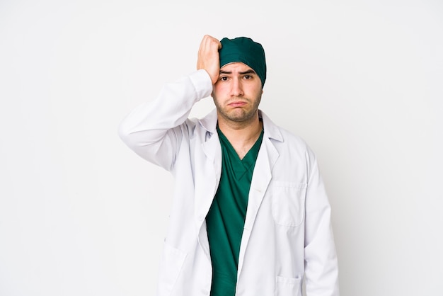 Young surgeon man being shocked