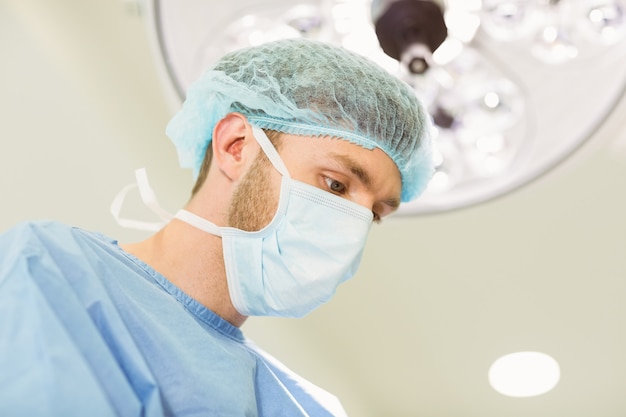 Young surgeon wearing mask and cap