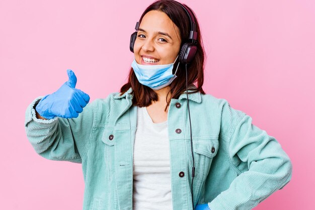 Young surgeon woman listening to music with headphones isolated