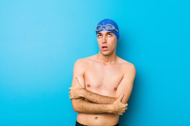 Young swimmer man tired of a repetitive task.