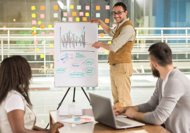 Young talented man is showing business plan project.