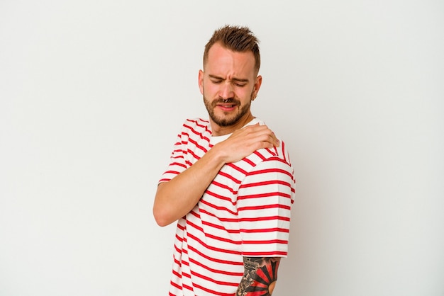 Young tattooed caucasian man isolated on white background having a shoulder pain.