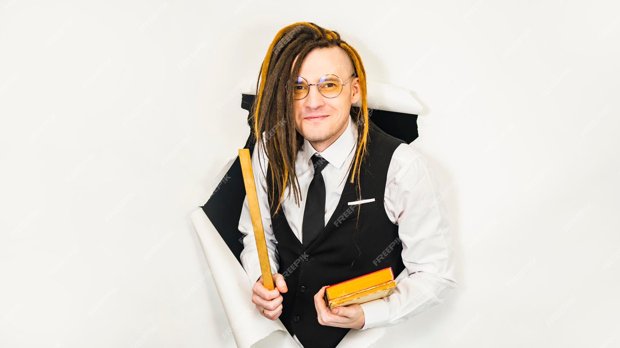 Premium Photo | Young teacher in glasses with ruler and books in hole of white  background male pedagogue with modern hairstyle dreadlocks looking at  camera in studio