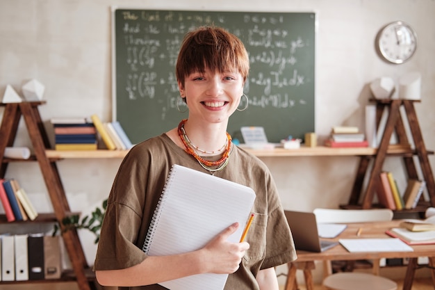 Young teacher standing in the classroom