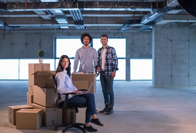 young team of business people in group, architect and engineer on construction site checking documents and business workflow using laptop computer in new startup office