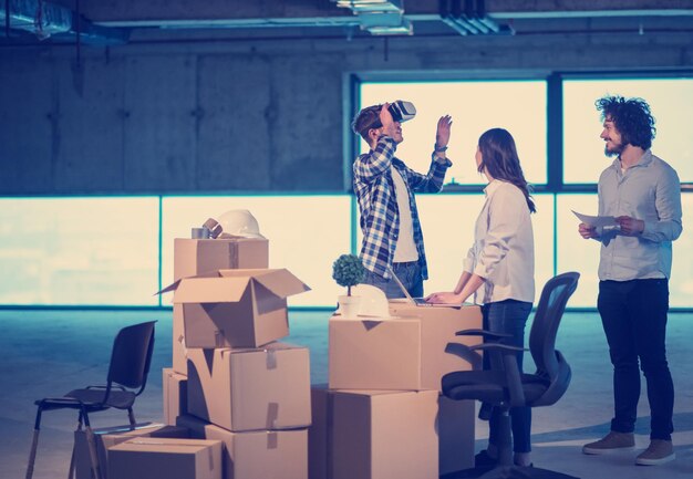 young team of business people in group, architect and engineer on construction site checking documents and business workflow using the virtual reality headset and laptop computer in new startup office