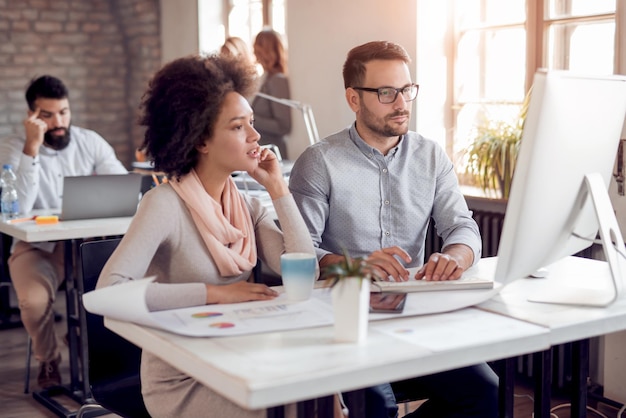 Young team of coworkers making great business discussion