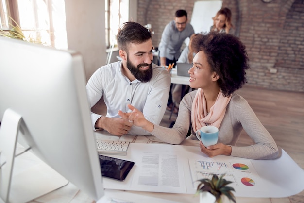 Young team of coworkers making great business discussion