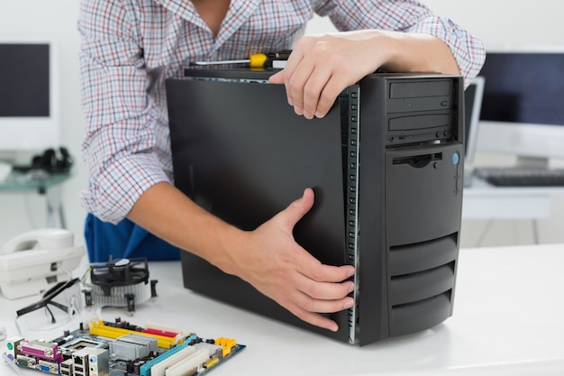 Young technician working on broken computer