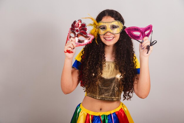 Young teen girl brazilian with frevo clothes carnival holding carnival masks