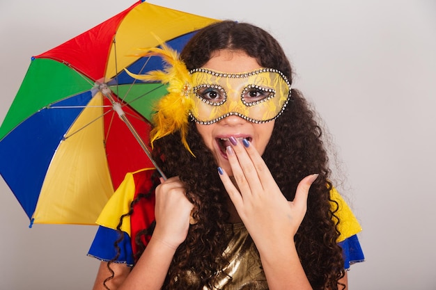 Young teen girl brazilian with frevo clothes carnival holding frevo umbrella incredible and unbelievable