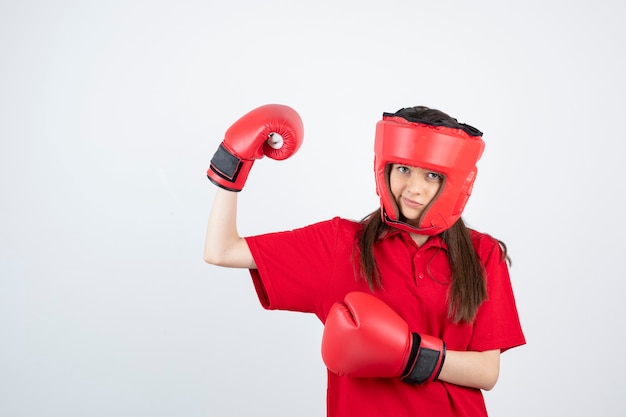 young teen girl in red uniform wearing boxing glove