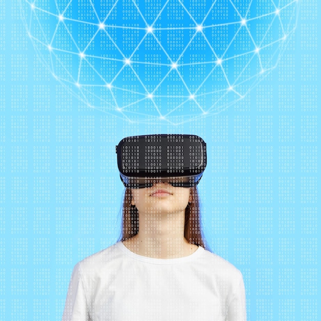 Young teen girl in a virtual reality helmet on a blue background plays a 3d computer game