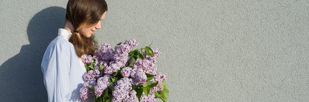 Young teen girl with bouquet of lilac