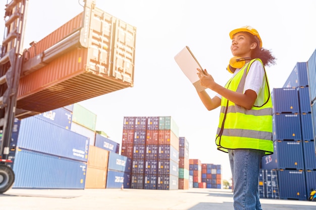 Young teen women happy staff worker enjoy working container loading in logistic port industry