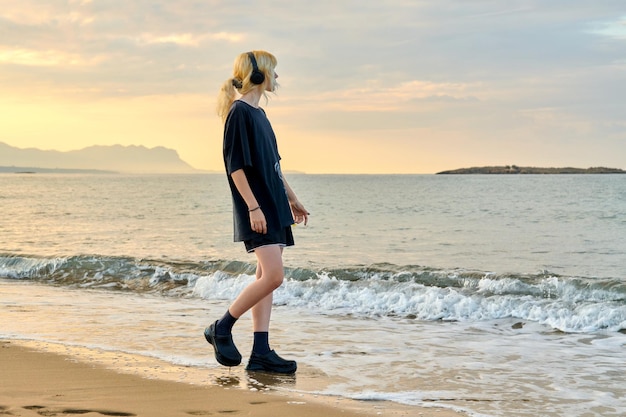 Young teenage female on the beach in the morning