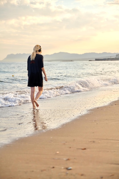 Young teenage female on the beach in the morning