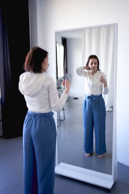 young teenage girl battling brain cancer looks at her reflection in the mirror