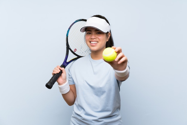 Young teenager Asian girl playing tennis