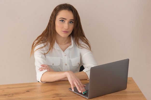 Young teenager girl is trained using a laptop computer