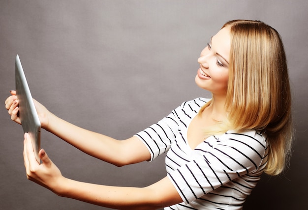 Young teenager girl taking selfie with digital tablet