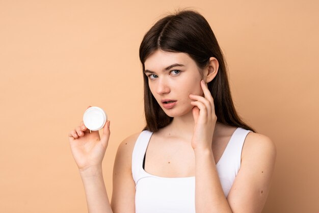 Young teenager with moisturizer