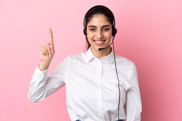 Young telemarketer over isolated background pointing up a great idea