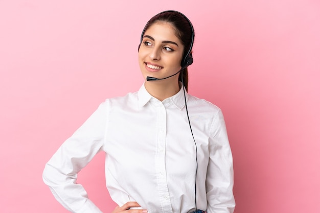 Young telemarketer over isolated background thinking an idea while looking up