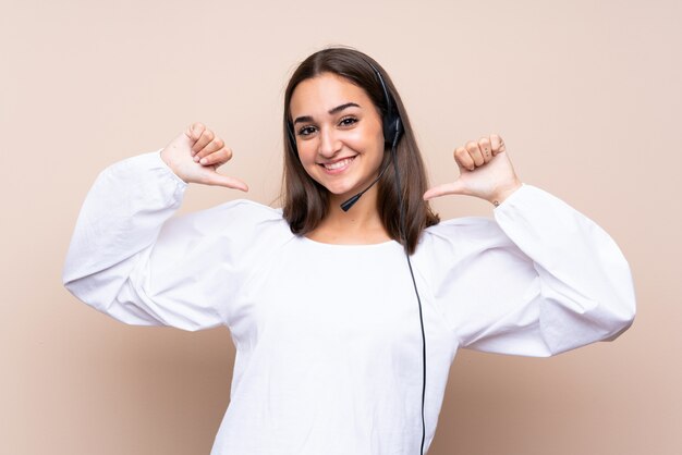 Young telemarketer woman over isolated  proud and self-satisfied