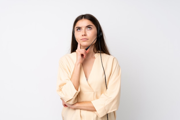 Young telemarketer woman over isolated white thinking an idea