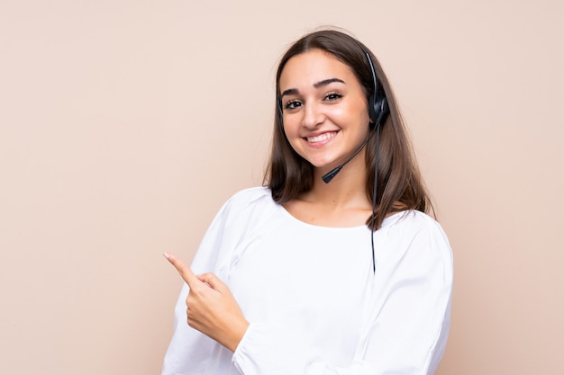 Young telemarketer woman pointing to the side to present a product
