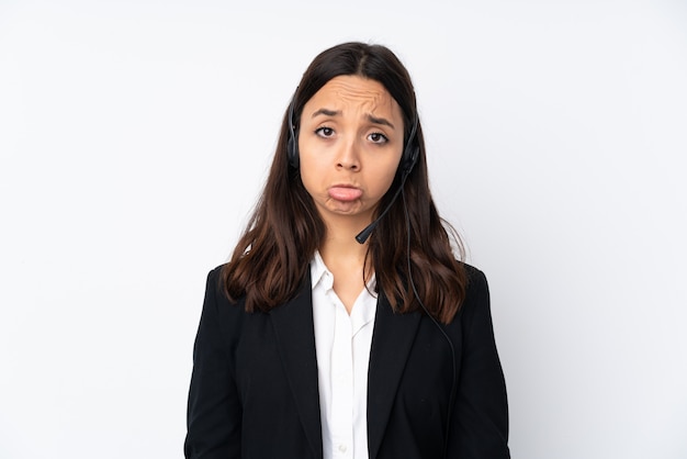 Young telemarketer woman on white with sad and depressed expression