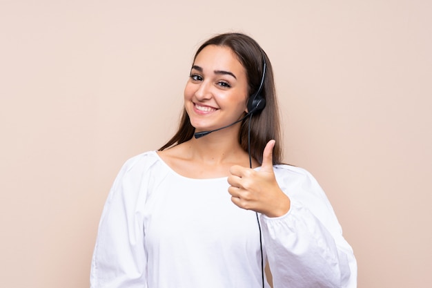 Young telemarketer woman with thumbs up because something good has happened