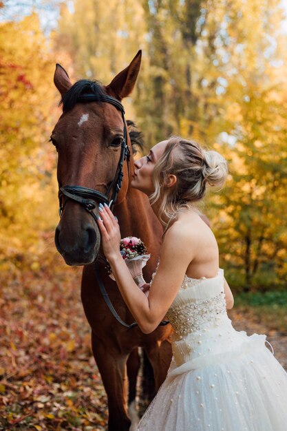 Photo young tender bride girl posing near in the autumn forest