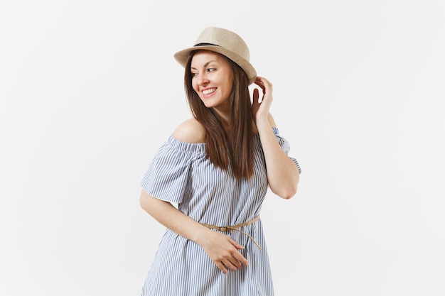 Young tender elegant charming woman dressed blue dress, cute hat with long brunette hair posing isolated on white background. People, sincere emotions, lifestyle concept. Advertising area. Copy space.