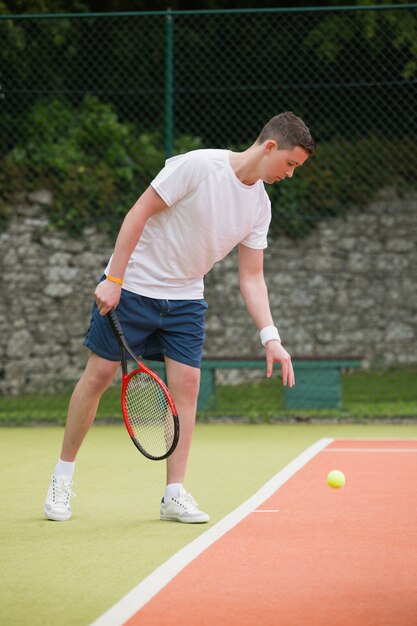 Young tennis player about to serve