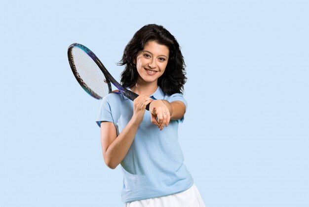 Young tennis player woman points finger at you with a confident expression