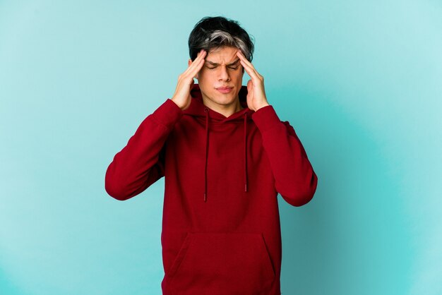 Young thin caucasian man expressing emotions isolated on blue background