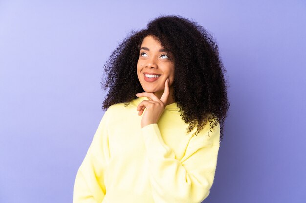 Young thoughtful woman in yellow blouse