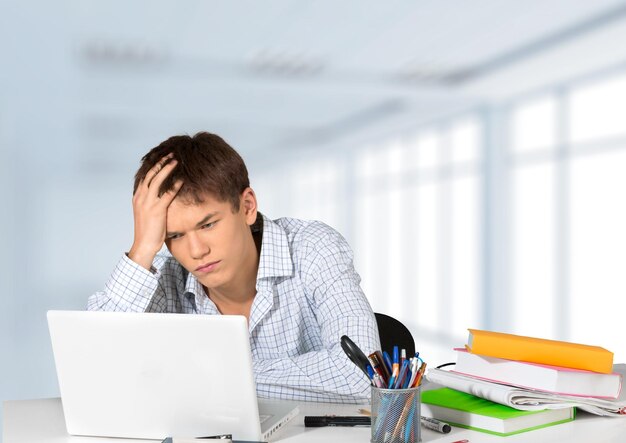 Young tired business man in suit on background