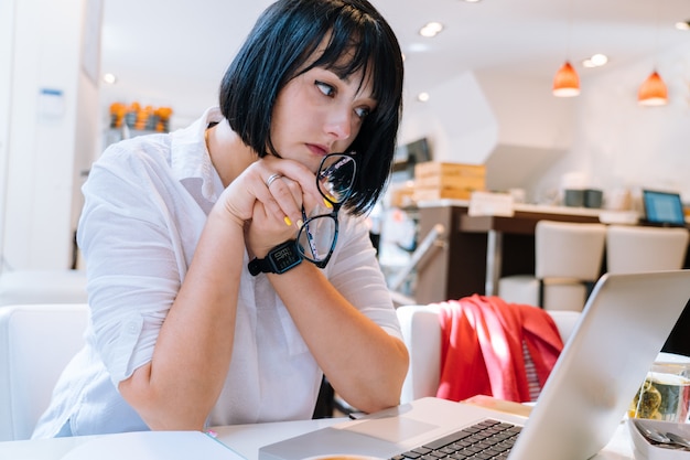 Young tired woman sitting in office