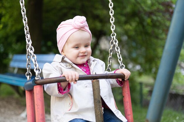 A Young Toddler Girl Swinging in a Park