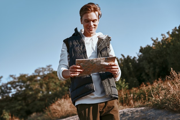 Young tourist blogger is exploring the map